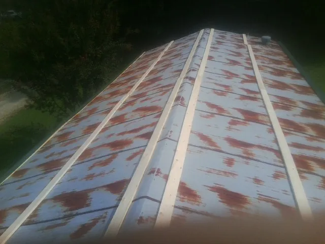 Rusted metal roof panels with new wood purlins before replacement — Storm Damage Roof Repair in Villanova by Roofing Brothers